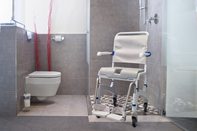 ... adjustable footrests, heel loops, height adjustable legs, with soft seat, hygiene opening, covered commode pan, 290lb capacity - Shown in bathroom