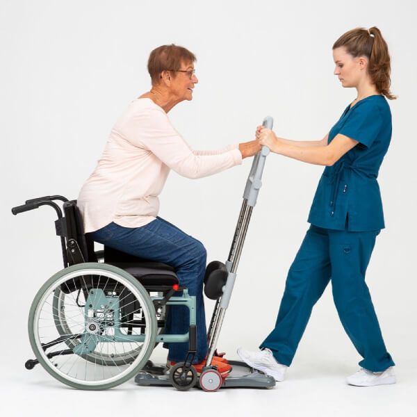 Elder woman using the Molift Raiser Pro Sit-to-Stand Patient Lift to sit down on wheelchair