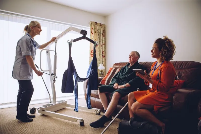 homecare-nurses-moving-elderly-patient-with-sling