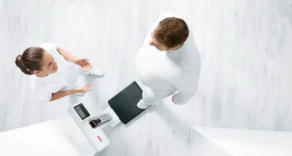 Patient going up to the Seca 777 scale with therapist