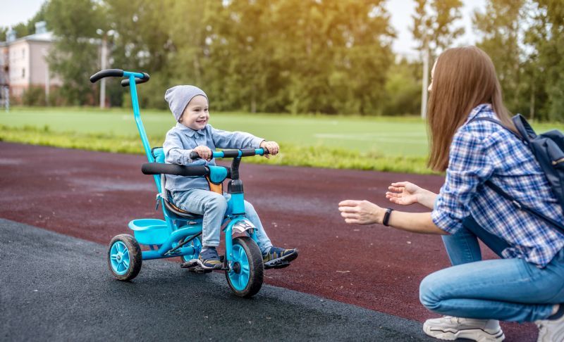 child-peddling-tricycle-to-mom