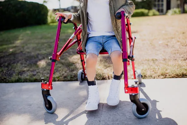Child sitting on the Drive Nimbo Posterior Pediatric Walker and Gait Trainer