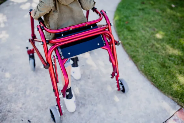 Child using the Drive Nimbo Posterior Pediatric Walker and Gait Trainer to walk steadily