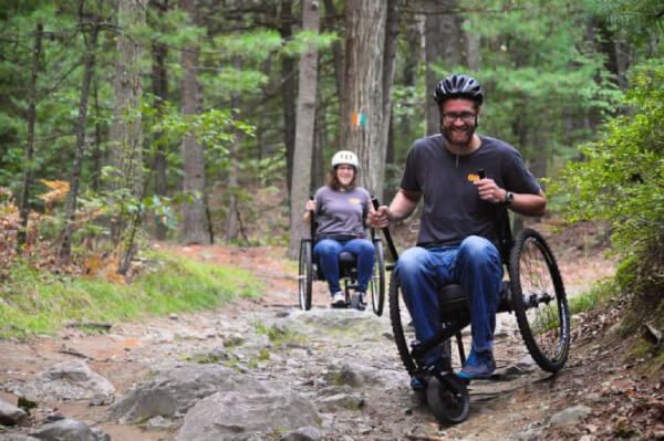 Couple exploring the woods with the GRIT Freedom Chair