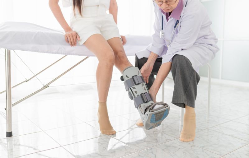 Doctor-fitting-patient-with-walking-boot
