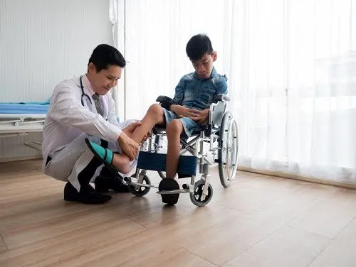 doctor treating boy in wheelchair