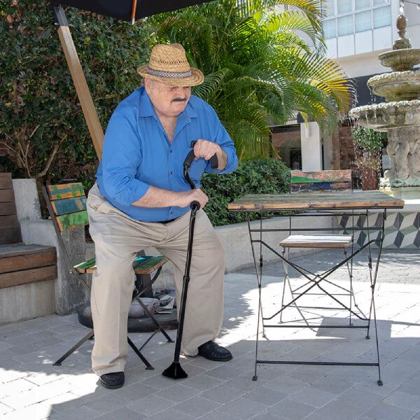 Elder man using the StrongArm Self Standing Cane - Support Cane to stand up