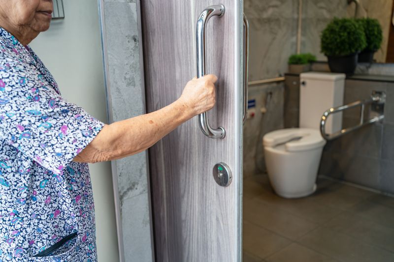elderly-woman-using-grab-bar-and-safety-frame