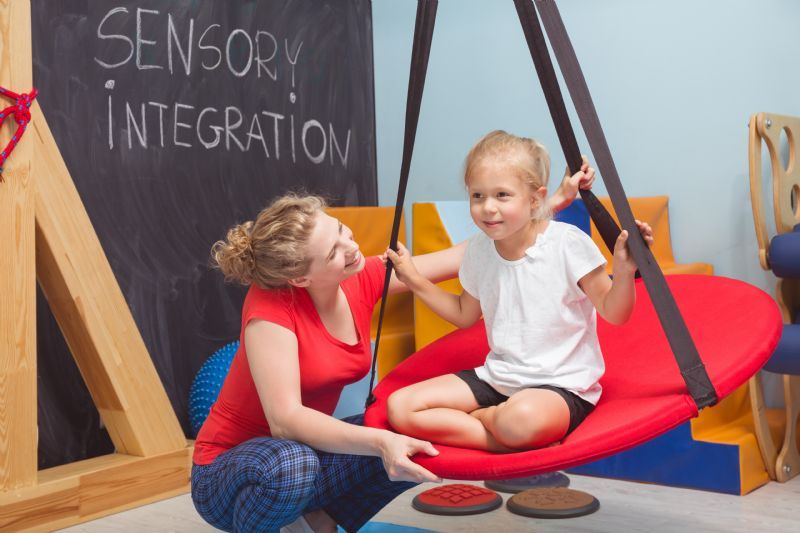 girl-swinging-in-sensory-integration-therapy