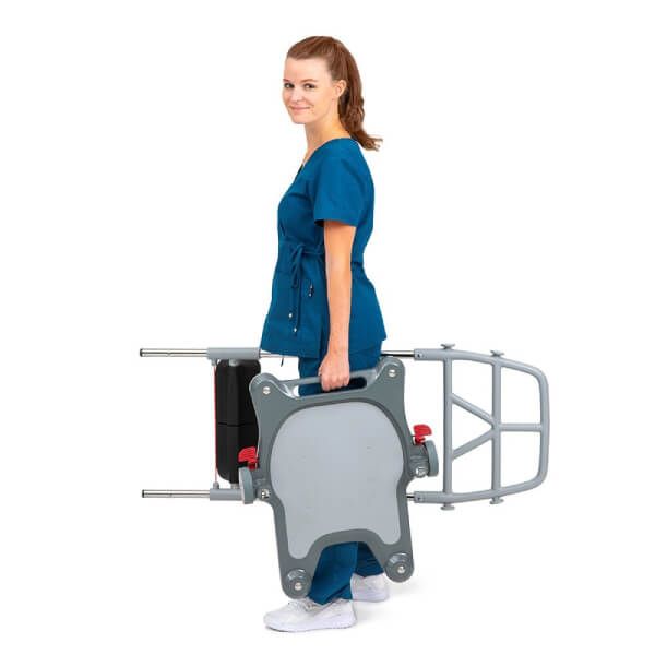 Healthcare provider carrying the Molift Raiser Pro Sit-to-Stand Patient Lift effortlessly