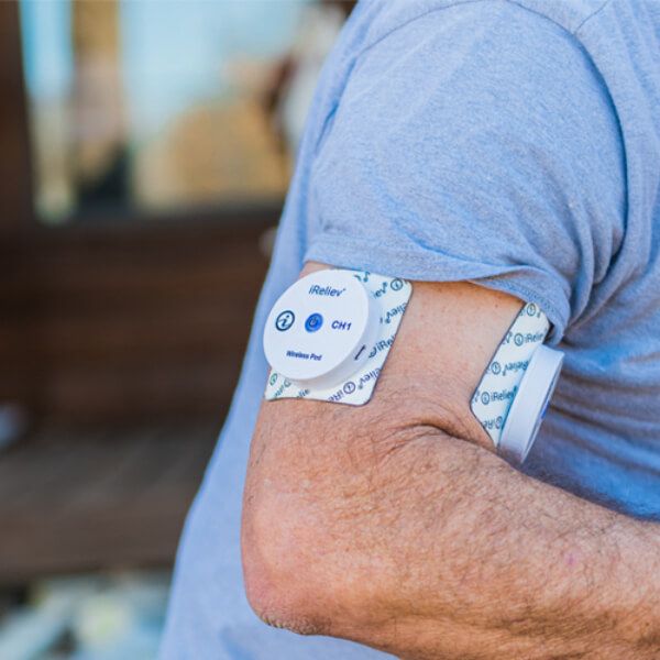 iReliev TENS Unit attached to person arm wireless