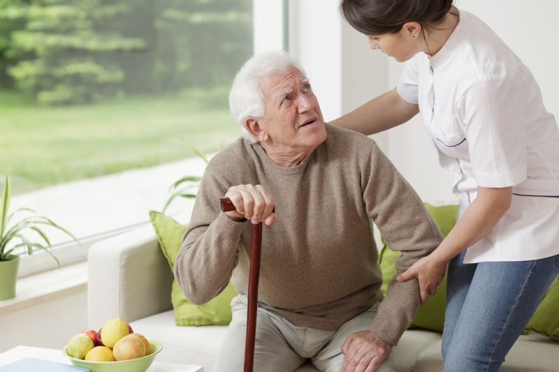Nurse-helping-elderly-man-stand
