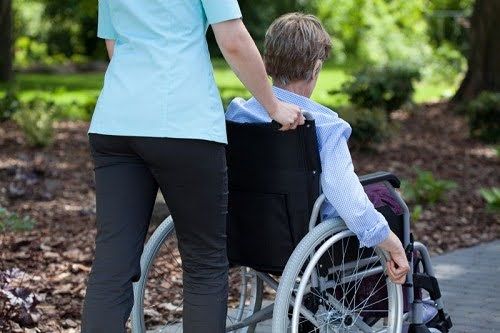 nurse-pushing-elderly-woman-in-wheelchair