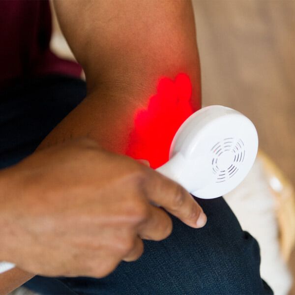 Person using the dpl Clinical Handheld Light Therapy by LED Technologies for arthritis relief