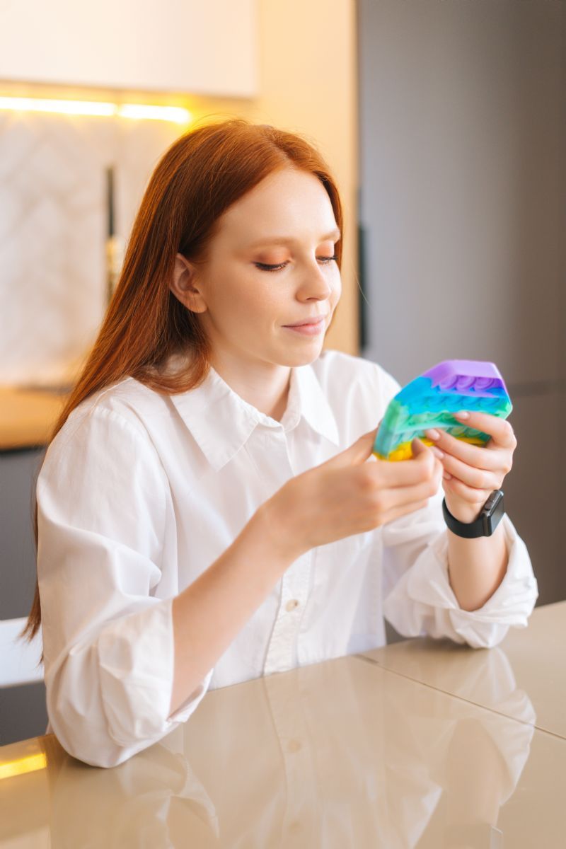 woman-playing-with-sensory-fidget-pop-toy