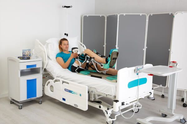 Woman enjoying the benefits of a Continuous Passive Motion Machine after surgery