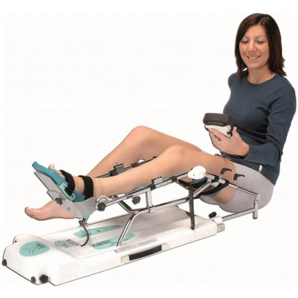 Woman using a Continuous Passive Motion Machine on her leg