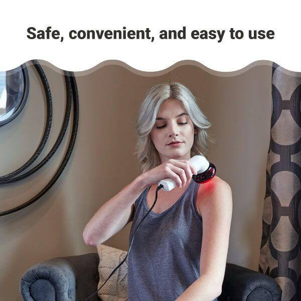 Woman using portable red light therapy lamp at home
