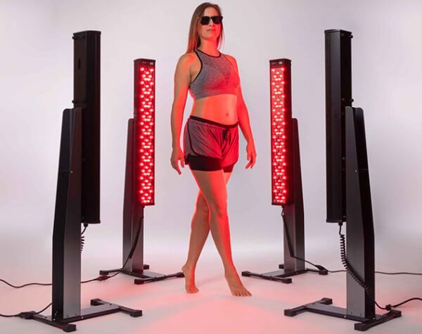 Woman using red light therapy to benefit full body