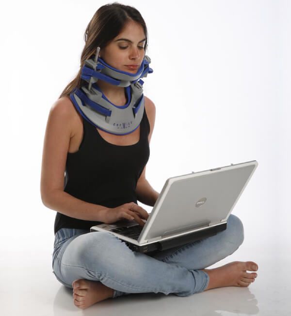 Woman working comfortable in laptop while using the Cervico2000 Cervical Decompression Device by Meditrac
